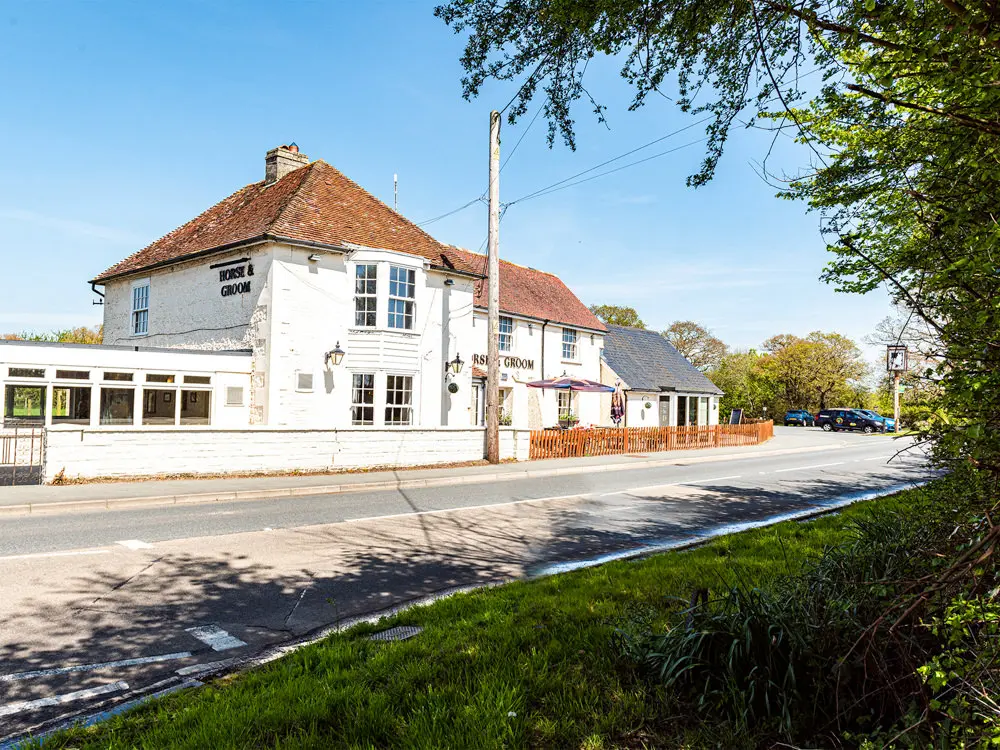 a view from thye road of the horse and groom